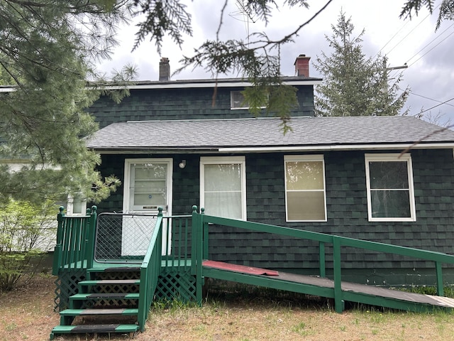 1902 W Ogilvie Ave, Baldwin, MI 49304 - view of front facade with a chimney and roof with shingles