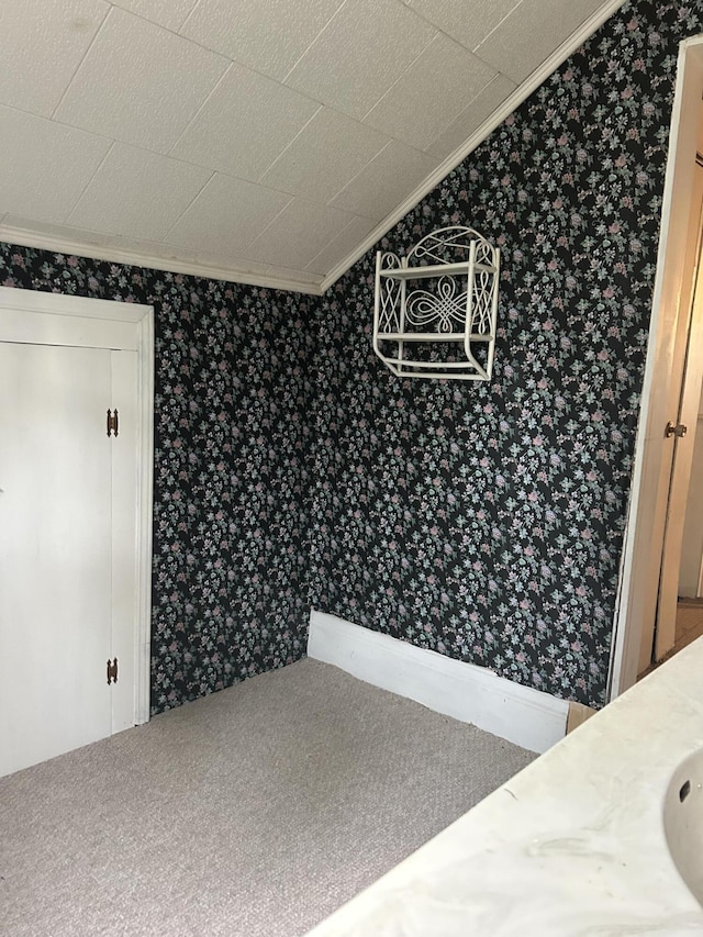 1902 W Ogilvie Ave, Baldwin, MI 49304 - unfurnished dining area with wallpapered walls and ornamental molding