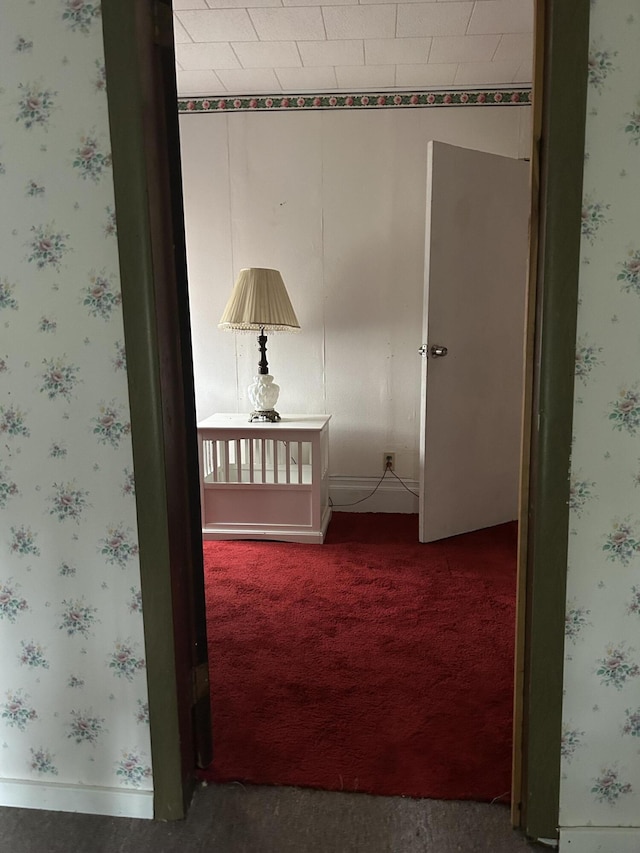 1902 W Ogilvie Ave, Baldwin, MI 49304 - hall featuring wallpapered walls, carpet flooring, and baseboards