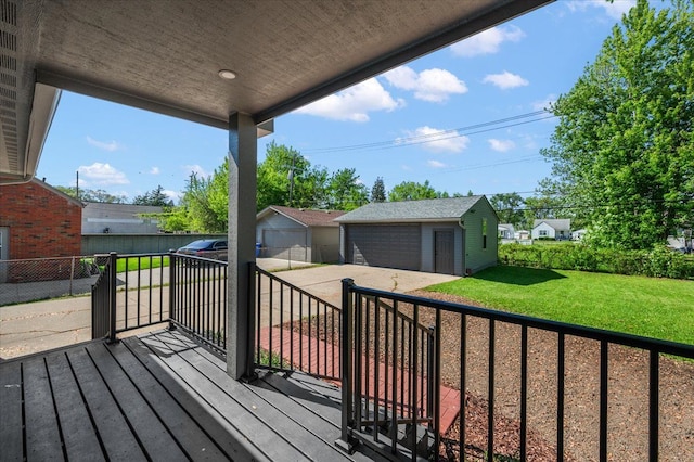 13665 Ida Ave, Warren, MI 48089 - wooden deck featuring a garage, a lawn, and an outbuilding