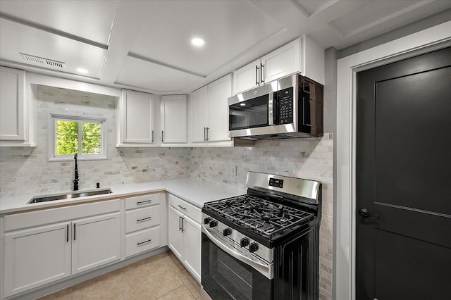 13665 Ida Ave, Warren, MI 48089 - kitchen with stainless steel appliances, a sink, tasteful backsplash, white cabinetry, and recessed lighting