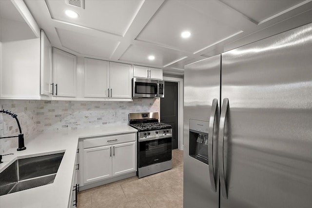13665 Ida Ave, Warren, MI 48089 - kitchen featuring stainless steel appliances, a sink, white cabinetry, backsplash, and light tile patterned floors