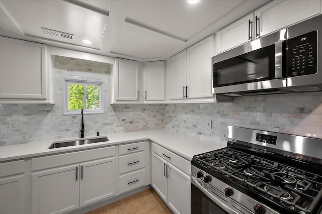 13665 Ida Ave, Warren, MI 48089 - kitchen featuring appliances with stainless steel finishes, a sink, white cabinets, tasteful backsplash, and light countertops