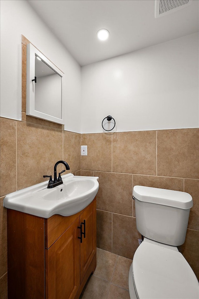 13665 Ida Ave, Warren, MI 48089 - half bath with tile walls, vanity, toilet, and a wainscoted wall
