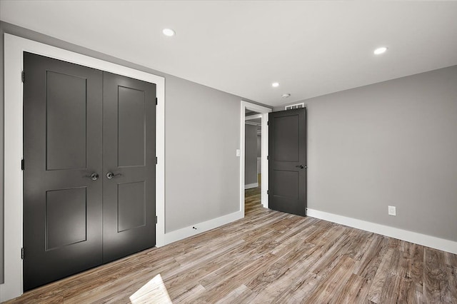 13665 Ida Ave, Warren, MI 48089 - unfurnished bedroom with a closet, light wood-type flooring, baseboards, and recessed lighting