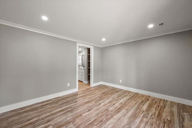 13665 Ida Ave, Warren, MI 48089 - empty room featuring light wood finished floors, crown molding, recessed lighting, and baseboards