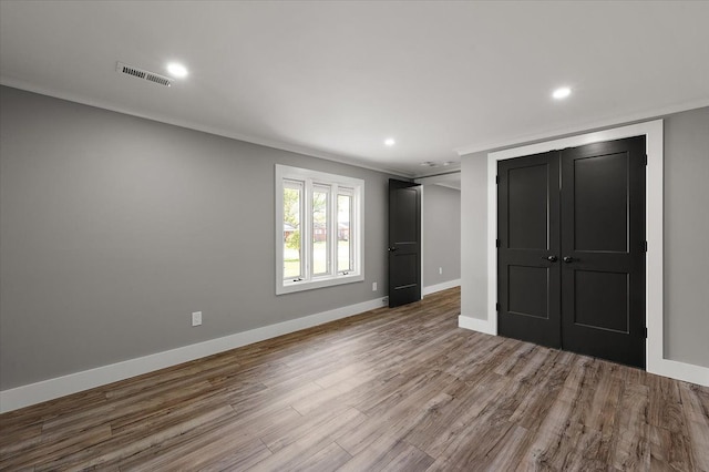 13665 Ida Ave, Warren, MI 48089 - unfurnished bedroom featuring wood finished floors, baseboards, crown molding, recessed lighting, and a closet