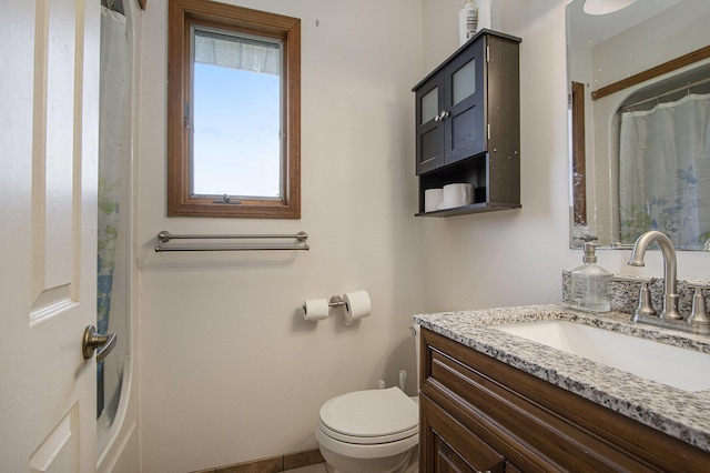 6528 Douglas Ave, Kalamazoo, MI 49009 - full bathroom with toilet, vanity, a shower with curtain, and tile patterned floors