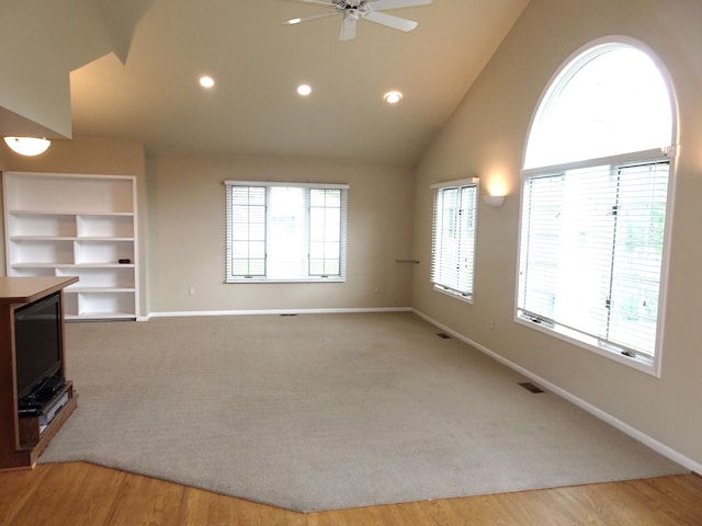 unfurnished living room with a ceiling fan, baseboards, recessed lighting, high vaulted ceiling, and built in shelves