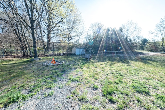 2330 N Rath Rd, Ludington, MI 49431 - view of yard with a fire pit, a shed, and an outdoor structure