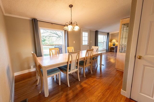 2330 N Rath Rd, Ludington, MI 49431 - dining space featuring a textured ceiling, a chandelier, wood finished floors, ornamental molding, and healthy amount of natural light