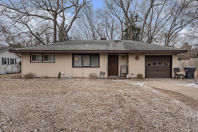 1772 Lombard St, Benton Harbor, MI 49022 - ranch-style house with an attached garage, fence, a chimney, roof with shingles, and driveway