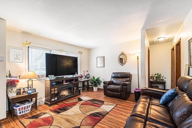 1772 Lombard St, Benton Harbor, MI 49022 - living room with wood finished floors, attic access, and a glass covered fireplace