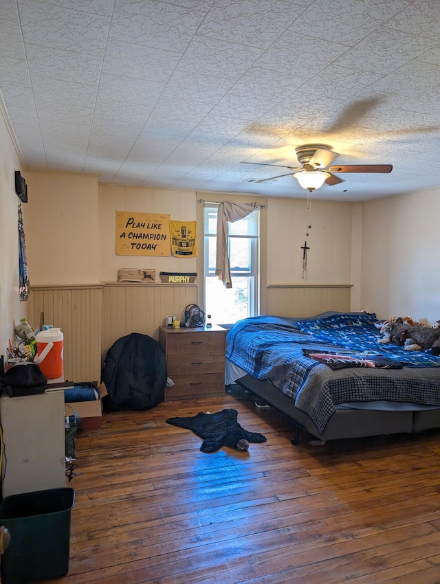 120 N Main St, Scottville, MI 49454 - bedroom featuring wood-type flooring, wainscoting, and ceiling fan