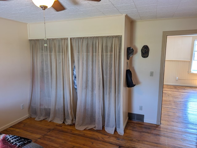 120 N Main St, Scottville, MI 49454 - empty room featuring wood-type flooring, a ceiling fan, and baseboards