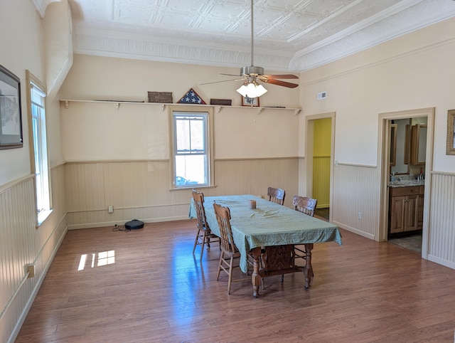 120 N Main St, Scottville, MI 49454 - dining space featuring wainscoting, wood finished floors, ornamental molding, ceiling fan, and an ornate ceiling