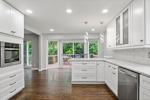 4578 Pine Village Dr, West Bloomfield, MI 48323 - kitchen featuring stainless steel appliances, a peninsula, healthy amount of natural light, recessed lighting, and glass insert cabinets