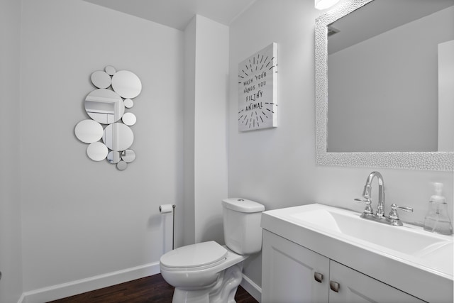 4578 Pine Village Dr, West Bloomfield, MI 48323 - bathroom featuring wood finished floors, baseboards, toilet, and vanity