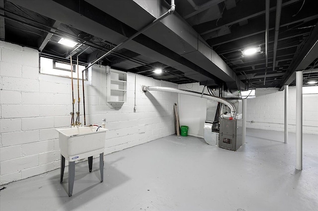 unfinished basement with heating unit and a sink