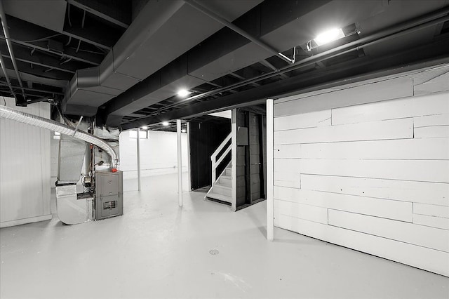 finished basement with stairs and heating unit