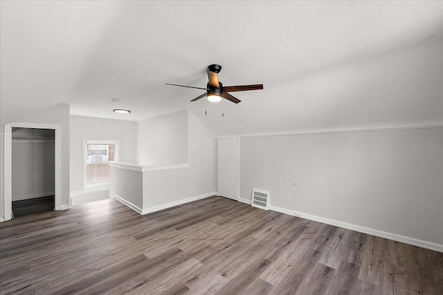 additional living space featuring ceiling fan, lofted ceiling, wood finished floors, and baseboards