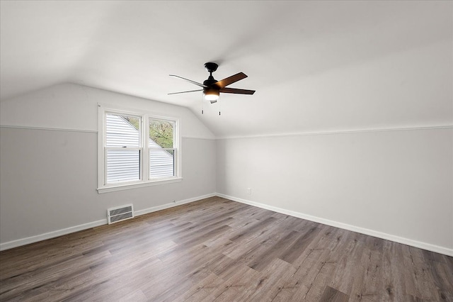 bonus room featuring lofted ceiling, a ceiling fan, wood finished floors, and baseboards
