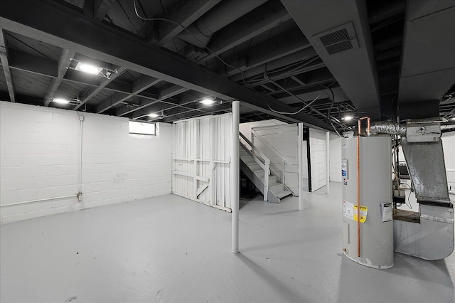 basement with water heater and stairs