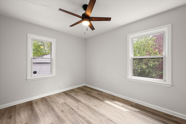 unfurnished room featuring wood finished floors, baseboards, and ceiling fan