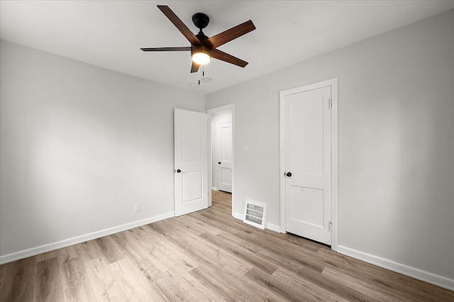unfurnished bedroom with light wood-style flooring, baseboards, and ceiling fan