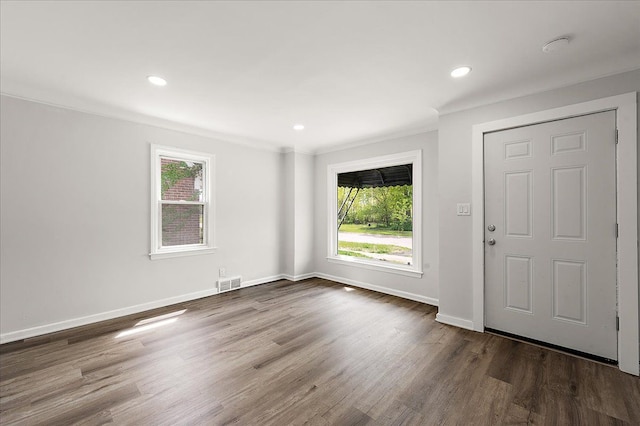 foyer entrance with plenty of natural light, baseboards, crown molding, wood finished floors, and recessed lighting