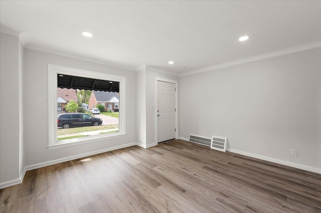 foyer entrance with wood finished floors, baseboards, recessed lighting, and crown molding