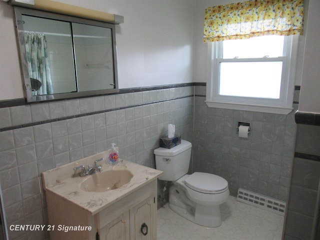 bathroom featuring tile walls, toilet, vanity, wainscoting, and curtained shower