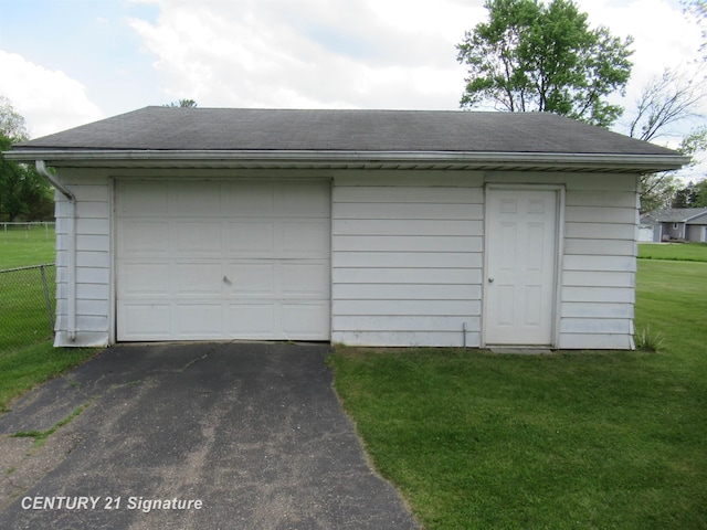 detached garage featuring driveway