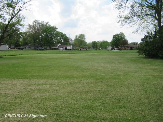 view of home's community with a lawn