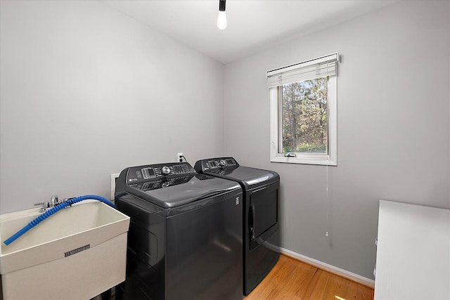 19880 Irving Dr, Livonia, MI 48152 - washroom featuring separate washer and dryer, wood finished floors, and baseboards