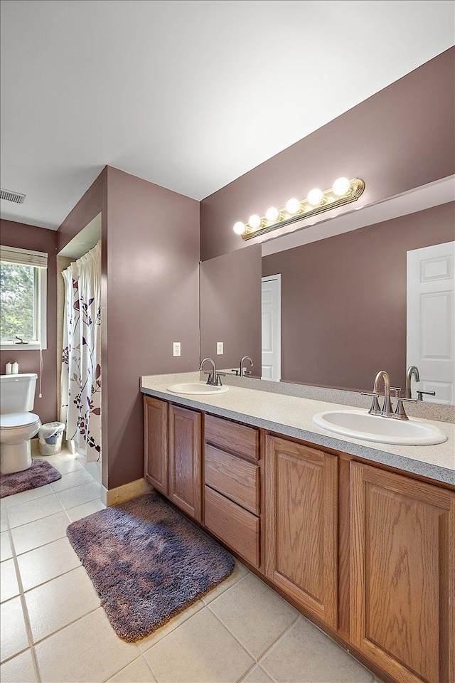 19880 Irving Dr, Livonia, MI 48152 - bathroom with toilet, double vanity, and tile patterned floors