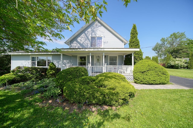 204 Parker St, Cement City, MI 49233 - view of front of property featuring a porch and a front lawn