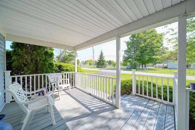 204 Parker St, Cement City, MI 49233 - deck featuring covered porch and a yard