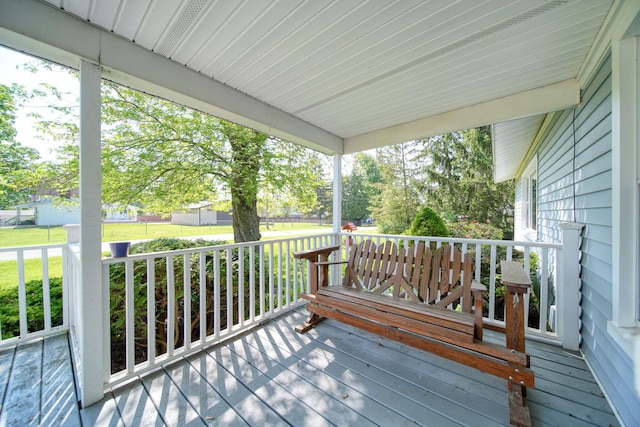204 Parker St, Cement City, MI 49233 - wooden deck with covered porch and a lawn