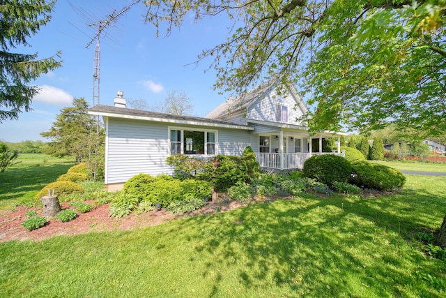 204 Parker St, Cement City, MI 49233 - view of home's exterior with a lawn, a porch, and a chimney