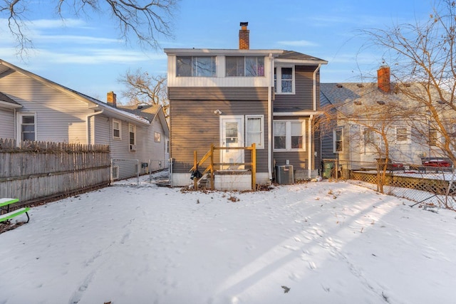 444 E Maplehurst St, Ferndale, MI 48220 - snow covered back of property featuring fence, central AC unit, and a chimney