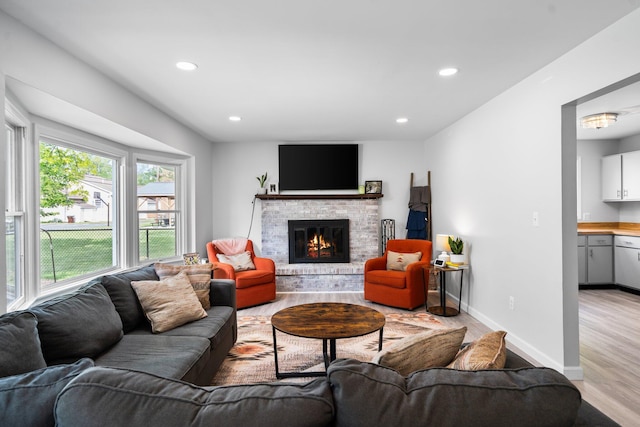 160 Cherry St, Milan, MI 48160 - living room featuring light wood finished floors, a fireplace, recessed lighting, and baseboards