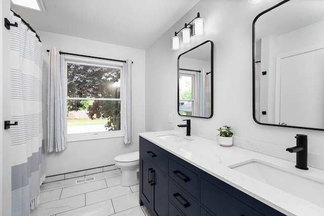 160 Cherry St, Milan, MI 48160 - bathroom featuring toilet, plenty of natural light, double vanity, and marble finish flooring