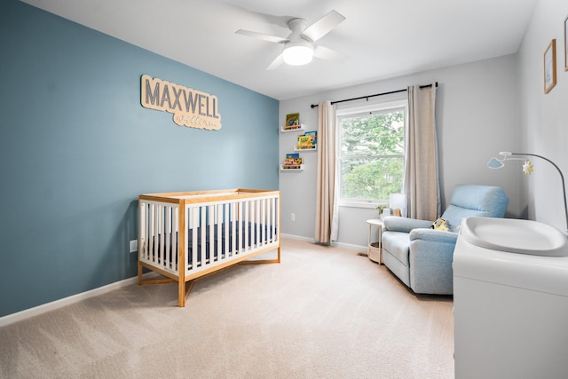 160 Cherry St, Milan, MI 48160 - carpeted bedroom featuring a crib, baseboards, and ceiling fan