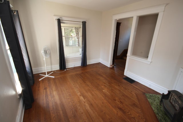 212 Rose Pl, Kalamazoo, MI 49001 - empty room with dark wood finished floors and baseboards
