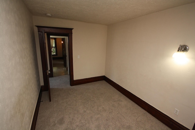212 Rose Pl, Kalamazoo, MI 49001 - unfurnished room featuring carpet floors, a textured ceiling, baseboards, and a smoke detector