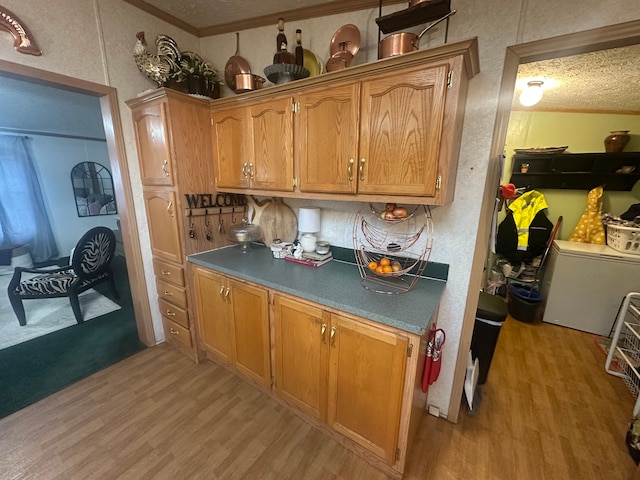 33332 Fern Ct, Lenox, MI 48048 - kitchen featuring light wood-style floors, a textured ceiling, brown cabinets, refrigerator, and ornamental molding