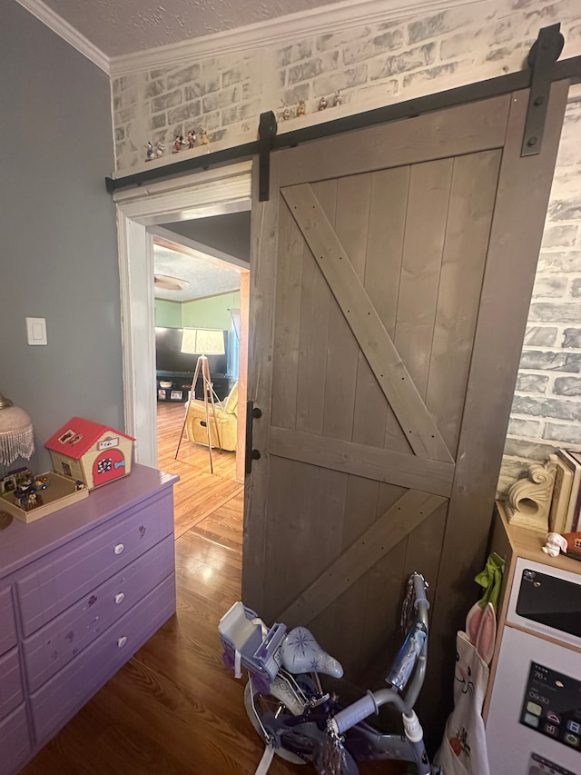 33332 Fern Ct, Lenox, MI 48048 - doorway with a barn door, wood finished floors, and ornamental molding