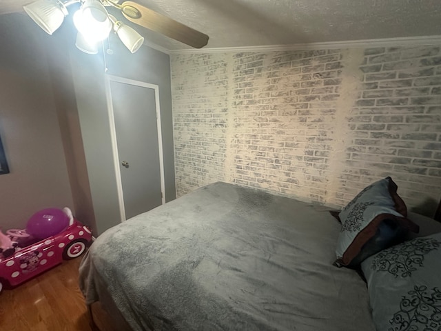 33332 Fern Ct, Lenox, MI 48048 - bedroom with crown molding, wood finished floors, ceiling fan, and a textured ceiling