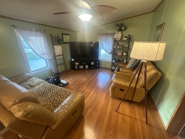 33332 Fern Ct, Lenox, MI 48048 - living area featuring vaulted ceiling, a textured ceiling, wood finished floors, plenty of natural light, and a ceiling fan